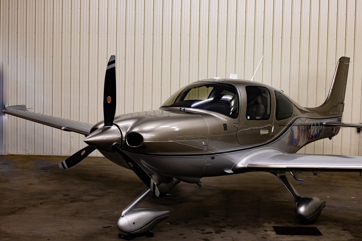 Small aircraft parked at the airport under a clear sky